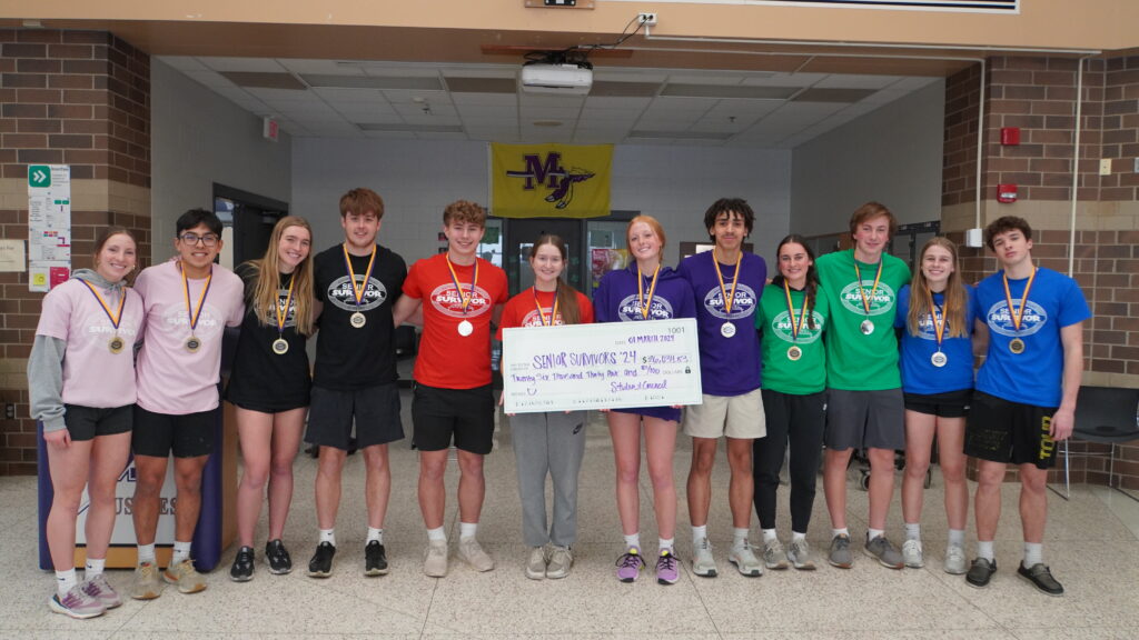 Photo of Muscatine High School Students holding a check celebrating the $26,000 raised for charities during senior survivor 2024. 