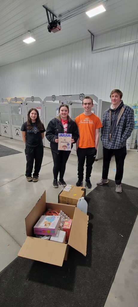 High school students dropping off donation at animal rescue place