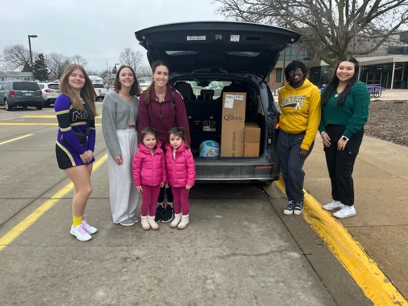 High school students delivering donations to local organization